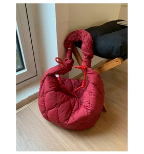 Détail du sac bouffant rouge avec matelassage en cœur et bandoulière à cordon froncé