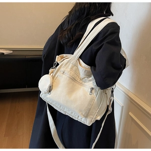 Detail of cream canvas tote bag with small round coin purse and zipper pocket