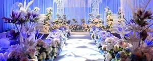 Elaborate laser-cut blue lace wedding cake wrappers and cupcake liners for elegant banquets