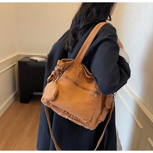 Model wearing a mustard yellow canvas tote bag with side pocket and small round coin purse