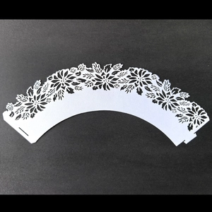 White laser-cut floral cupcake wrappers with pearlescent finish for wedding decor