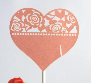 Hollow rose lace heart-shaped cake topper in pearlized rose gold finish for birthdays