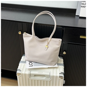 Close-up of off-white lychee pattern leather tote bag with elegant long shoulder straps