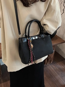 Elegant black canvas tote bag with PU leather trim and stylish tennis racket pendant