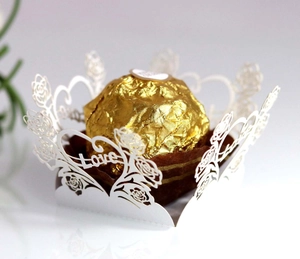 Detail of laser-cut wedding favor box with white rose and heart love hollow patterns