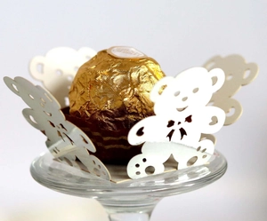 Macro shot of white laser-cut teddy bear chocolate wrapper with cute bowtie details
