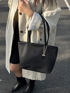 Chic black litchi pattern leather tote bag with chain charm shown on model