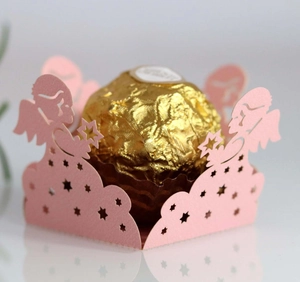 Macro detail of pink laser-cut candy box with angel and star patterns for Ferrero gift