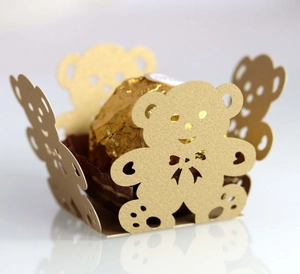 Golden laser-cut bear chocolate box with shimmering metallic finish for party favors