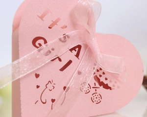 Pink heart-shaped girl baby shower gift box with IT'S A GIRL laser cut design and ribbon