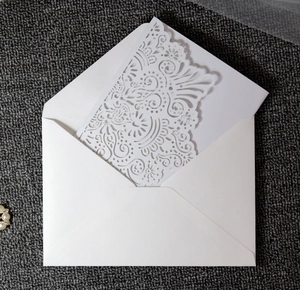 Detailed laser cut white wedding invitation set with elegant floral vine hollow pattern