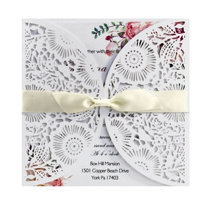 Elegant laser-cut floral wedding invitation set with pink card and yellow ribbon bow