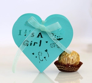 Detail of teal laser-cut heart candy box with It's A Girl text and ribbon bow