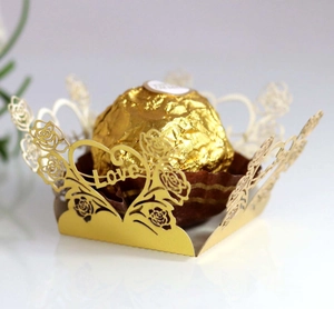 Close-up of laser-cut gold chocolate wrapper with rose motifs and Love engraving