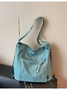 Mint green large capacity nylon shoulder bag with water resistant texture and zipper pocket