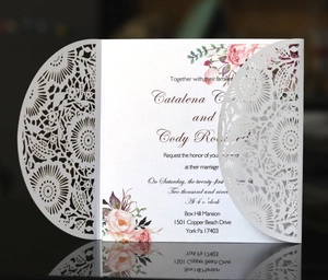 Elegant laser cut floral wedding invitation with intricate lace detail and pink flowers