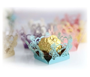 Laser-cut heart and floral paper chocolate liners in various colors for party favors