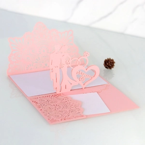 Detailed 3D laser-cut wedding card featuring Mr & Mrs silhouettes and ring design