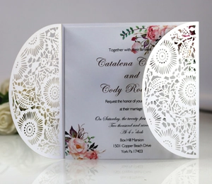 Detailed view of laser-cut wedding invitation with elegant floral hollow patterns