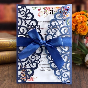 Navy blue laser cut wedding invitation with satin bow and pink floral inner card