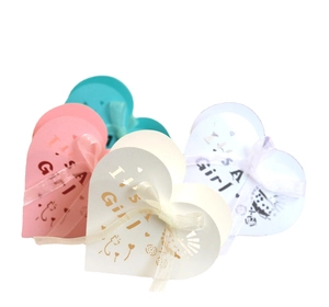 Pink and white 'It's a Girl' laser cut candy boxes with silk ribbons for baby shower
