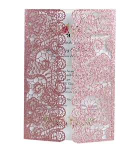 Detail of pink laser cut lace wedding invitation with glitter finish and floral inner card