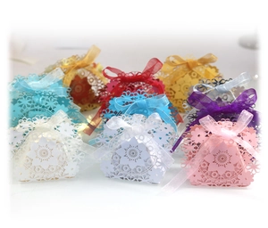 Laser-cut floral wedding favor boxes with ribbons in various colors for party gifts