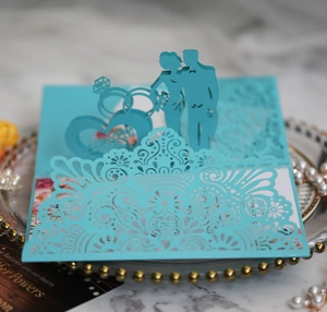 Detail view of 3D pop-up blue wedding card with intricate laser-cut silhouette design