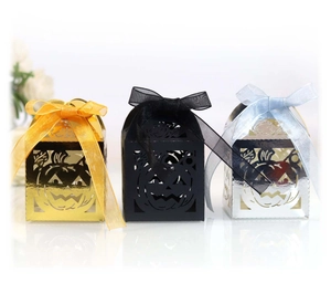 Three Halloween hollow pumpkin candy boxes in gold, black and silver with ribbon bows