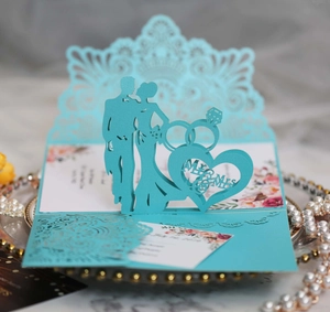 Detail of laser-cut 3D wedding invitation with Mr & Mrs design and ring silhouette