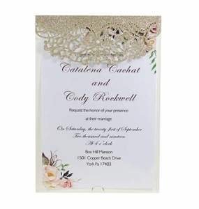 Detail of laser-cut glitter wedding invitation with elegant floral insert and calligraphy