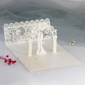 Detailed 3D laser-cut wedding invitation featuring a romantic couple silhouette and floral arch