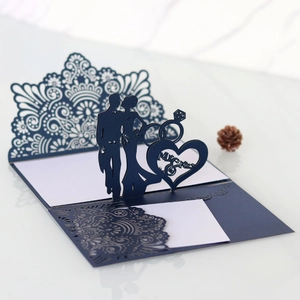 Detail of laser-cut wedding invitation featuring mandala patterns and Mr & Mrs silhouettes