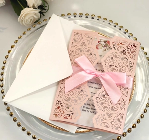 Pink laser-cut floral wedding invitation set with silk ribbon and white envelope