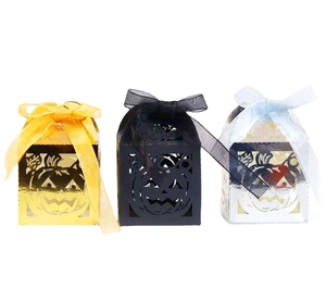 Hollow pumpkin Halloween gift boxes in gold, black, and silver with elegant ribbons