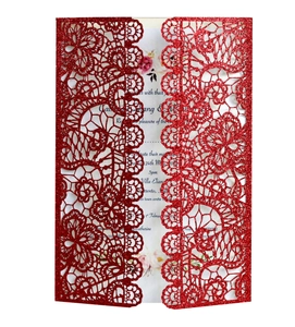 Macro detail of red glitter lace laser-cut wedding invitation with elegant floral design
