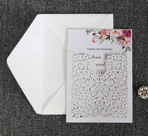 Detail of laser-cut floral invitation set including white sleeve, inner card and envelope