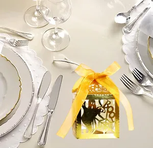 Laser-cut Halloween candy box with spider web and ghost patterns in gold paper