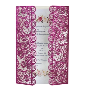 Macro detail of fuchsia glitter laser-cut floral wedding invitation with inner card