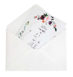 Detailed laser-cut wedding invitation featuring elegant floral patterns and couple silhouettes
