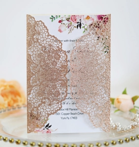Detail of rose gold laser-cut glitter wedding invitation with elegant floral inner card
