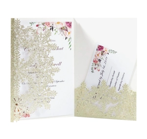 Macro detail of laser-cut glitter wedding invitation with floral insert and RSVP card