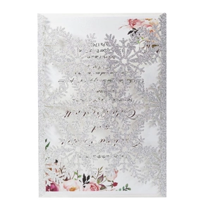 Macro view of laser-cut snowflake hollow on silver glitter paper greeting card