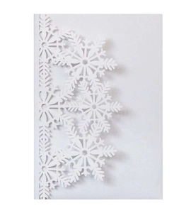 Macro shot of intricate laser-cut snowflake patterns on premium white cardstock paper
