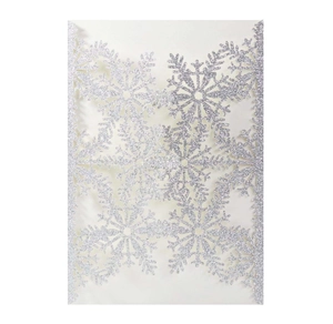 Detail of silver glitter laser cut Christmas snowflake greeting card with intricate patterns