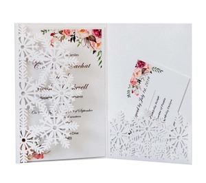 Detail of laser-cut snowflake wedding invitation with elegant floral printing