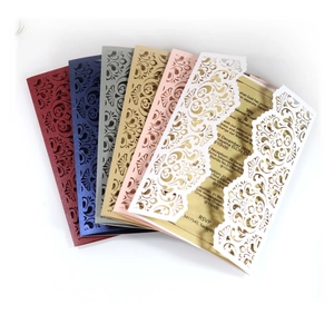 Laser cut floral wedding invitations in assorted colors with champagne gold inserts