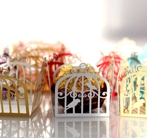 Detailed laser-cut birdcage pattern on white pearl paper chocolate wrapper for weddings