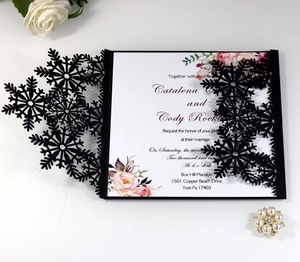 Detailed laser-cut snowflake invitation cover with floral inner card for winter wedding