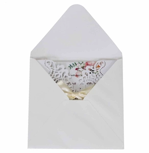 Laser cut wedding invitation set with cream ribbon bow and floral inner card